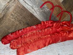 three red umbrellas sitting on top of a wooden floor