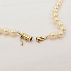 A very fine single strand of cultured pearls.  With 7 mm round white pearls and a 14k gold barrel clasp.  Enduring classic style!  Date: 20th Century  Overall Condition: It is in overall good, used estate condition with some very fine & light surface scratches and other signs of light wear consistent with age.  Fineness: Marked 14k to the clasp for gold fineness.  Measurements: Length: ca. 31.5 in. (ca. 800 mm) Diameter: ca. 7 mm  Gemstones: 91 pearls: ca. 7 mm  Weight: ca. 53 grams Vintage Pearls, Cultured Pearls, Pearl White, Barrel, Classic Style, Chain Necklace, Chain, Gemstones, Gold