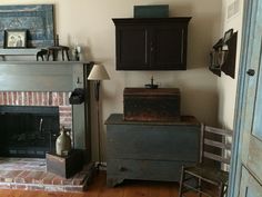 a living room filled with furniture and a fire place in front of a brick fireplace