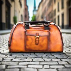 Saidah Duffle Bag - Premium Luxury Travel from Que Shebley - Shop now at Que Shebley Luxury Tote Weekender Bag, Cognac Leather Weekender Bag For Travel, Luxury Cognac Briefcase For Travel, Classic Large Capacity Duffle Bag For Trip, Cognac Weekender Bag With Leather Lining For Travel, Luxury Rectangular Weekender Bag For Weekend Trips, Luxury Large Capacity Satchel For Weekend Trips, Classic Rectangular Duffle Bag For Trips, Cognac Duffle Bag With Luggage Sleeve For Overnight Trips