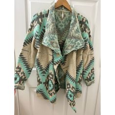 Never Worn Cozy Cardigan In A Beautiful Turquoise/Teal Tribal Print. Very Thick Heavy Quality. From A Local Boutique. Green Bohemian Cardigan For Fall, Bohemian Green Cardigan For Fall, Fall Green Bohemian Cardigan, Turquoise Long Sleeve Sweater For Winter, Casual Turquoise Winter Outerwear, Casual Turquoise Winter Sweater, Green Bohemian Outerwear For Layering, Bohemian Green Outerwear For Layering, Blue Bohemian Sweater For Layering