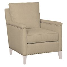 the arm chair is upholstered with studding on it's back legs