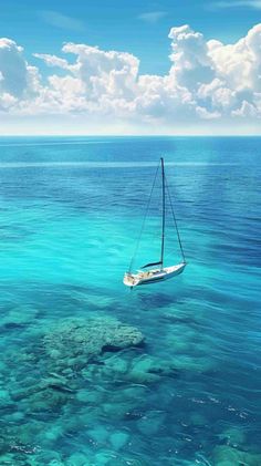 a sailboat floating in the middle of clear blue water with corals around it