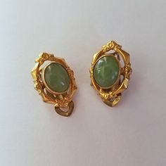 This is a pair of vintage estate jade earrings made in the 60's in their original box. They are genuine with ornate 12K gold filled oval frames. Vintage Yellow Gold Clip-on Earrings, Art Deco Oval Earrings For Formal Occasions, Oval Art Deco Earrings For Formal Occasions, Formal Oval Art Deco Earrings, Victorian Gold Cabochon Earrings, Victorian Oval Earrings For Collectors, Gold Victorian Cabochon Earrings, Collectible Victorian Oval Earrings, Gold Jade Wedding Earrings