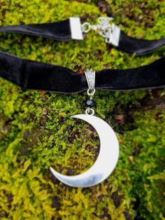 Velvet style choker with large silver style crescent moon. Choker 12+3 inches, pendant 1.7 inches Zinc Alloy silver plated Silver Moon-shaped Halloween Jewelry, Gothic Festival Jewelry With Moon Charm, Silver Halloween Festival Choker, Black Moon Charm Jewelry For Festivals, Halloween Festival Silver Choker, Silver Choker For Halloween Festival, Black Jewelry With Moon Charm For Festivals, Black Moon Phase Jewelry For Festivals, Silver Witchy Choker Jewelry