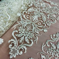 Be the envy at any special occasion with this beautiful Corded Bridal Lace Fabric Embroidered on 100% Polyester Net Mesh by Lace USA. The accented embroidery is a perfect addition to the corded lace fabric which comes in 5 sophisticated colors, making it ideal for wedding dresses, evening gowns, dance costumes, and quinceanera dresses. As the finest in corded couture lace, this product is sure to make you the center of attention when you strut your stuff in this elegant lace fabric. The high qua Elegant Embroidered White Lace, Elegant Lace Fabric With 3d Embroidery, Elegant Embroidered Lace Tulle Fabric, Elegant Floral Embroidered Tulle Fabric For Ceremony, Elegant Embroidered Fabric For Mother Of The Bride, Elegant Lace Fabric With Resham Embroidery, Elegant Lace Embroidered Fabric For Ceremony, Cream Resham Embroidered Fabric For Party, Elegant Tulle Fabric With 3d Lace Embroidery