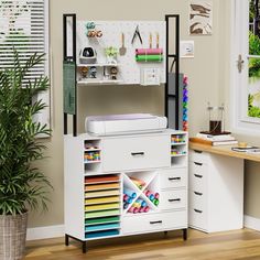 a white desk with drawers, printer and other office supplies on the shelf next to it