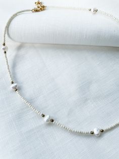 "Ivory seed beads with natural pearls and 3mm faceted hematite spacers. Necklace had lobster clasp closure with 2\" adjustable chain. Each piece is designed and handmade in Brooklyn. After visiting the Notre Maison orphanage in 2015, I fell in love with the children and knew I wanted to help sponsor them. That's what started this shop. Every purchase helps us sponsor 5 children at the orphanage that we follow up with and visit over the summers. Join our Ubuntu family so that together we can be t Adjustable Pearl Beaded Necklace With Round Beads, Adjustable Pearl Beaded Necklace With Spacer Beads, Adjustable Faceted Bead Pearl Necklace, White Pearl Jewelry With Oval Beads, White Pearl Jewelry With Faceted Beads, Adjustable Pearl Beaded Necklace With Faceted Beads, White Beaded Necklace With Pearl Drop For Gift, Adjustable White Pearl Beaded Necklace, Adjustable Pearl Necklace With Beaded Chain