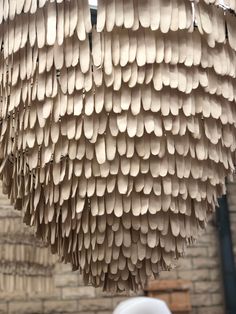 a chandelier made out of paper is hanging from the ceiling