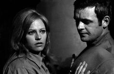 black and white photo of man and woman looking at each other with serious expressions on their faces