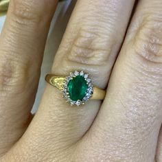 Metal: 14kt Yellow Gold Stone: Diamond And Emerald Shape: Round And Oval                                                                                                                                                Emerald Measurements: 7.00 x 5.00 mm   Approxate Emerald Weight: .78 ctw     Color: Green   Approxate Diamond Weight: .20 tcw Approximate Of Diamonds: SI quality And H-I Color  Measurements Of Center Halo On Ring: 10.00 x 10.00 mm Width Of Shoulder: 5.00 mm Hight Of Ring From Top To Classic Gold Emerald Ring With Halo Setting, Elegant Marquise Emerald Ring With Center Stone, Formal May Birthstone Diamond Ring With Halo Design, Classic Marquise Emerald Ring, Elegant Yellow Gold Emerald Anniversary Ring, Fine Jewelry Emerald Ring With Marquise Brilliant Cut, Classic Marquise May Birthstone Jewelry, Fine Jewelry Marquise Emerald Ring With Brilliant Cut, Timeless Emerald Ring With Halo Design For Anniversary