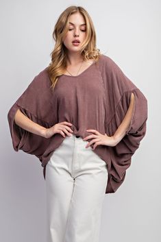 Easel's Mineral Washed Gauze Loose Fit Top features batwing/dolman sleeves, v-neckline and a boxy and oversized silhouette for a stylish, relaxed look. The soft and lightweight mineral washed gauze material adds breathability and comfort. Material and Care 100% Rayon Hand Wash Cold Hang to Dry Measurements Small Bust:38" Length: 27 ” Sleeve Length:20” Medium Bust:40” Length:28 ” Sleeve Length:21” Large Bust:42 ” Length:29 ” Sleeve Length:22” Casual Butterfly Sleeve Blouse For Fall, Oversized V-neck Poncho For Spring, Billowy V-neck Tops For Fall, Trendy Oversized V-neck Blouse, Casual Billowy V-neck Tops, Casual Tops With Kimono Sleeves For Fall, Casual Fall Tops With Kimono Sleeves, Oversized Batwing Sleeve Poncho For Spring, Oversized Short Sleeve Poncho