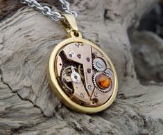 Unique Steampunk Necklace - Copper ☣ This necklace features a light copper / rose gold coloured vintage watch mechanism, embellished with a 'Copper' Swarovski crystal. The intricate mechanics of the antique timepiece look beautiful and make a very striking focal point for this unique pendant. The photos speak for themselves really, this is a one of a kind, eye catching and stunning necklace. Gold plated stainless steel backed and it comes on a stainless steel chain, please choose the length you Vintage Gold Pocket Watch In Stainless Steel, Gold Metal Pocket Watch With Chain, Gold Steampunk Pocket Watch With Locket, Gold Steampunk Round Pendant Jewelry, Gold Steampunk Jewelry With Round Pendant, Vintage Skeleton Dial Jewelry As Gift, Vintage Skeleton Dial Jewelry Gift, Bronze Round Steampunk Jewelry, Skeleton Dial Metal Jewelry As A Gift