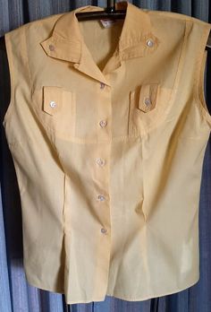 In all my years of collecting, I rarely came upon cool blouses from 50s-60s.  This is a real nice one.  It really in in very good condition.  All I found was one small but inconvenient spot( see pic) and one of the buttons is broken.  I did not try to remove stain.  Armpit to armpit is 18 inches.  Waist is 31 inches.  No give to fabric.  Sale is final. Vintage Solid Summer Blouse, Vintage Yellow Sleeveless Top, Classic Yellow Summer Blouse, Yellow Sleeveless Blouse For Work, Vintage Sleeveless Tops For Daywear, Vintage Sleeveless Buttoned Tops, Vintage Sleeveless Daywear Blouse, Vintage Sleeveless Blouse For Daywear, Fitted 1950s Summer Tops