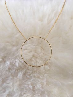 "Handmade necklace consisting of a large single circle strung from a delicate chain. The chain shown is 18\", but custom lengths are welcomed. Available in silver and gold. This unique necklace is perfect for anyone loves accessorizing with on trend, modern or minimalist jewelry. Made from high quality 16k gold plated brass. It has an effortless chic vibe to it and is great for layering. All jewelry is lovingly made in Massachusetts and ships profesionally packaged in an attractive box, ready to Circle Shaped Yellow Gold Necklace With Adjustable Chain, Metal Necklace Full Circle For Gift, Minimalist Metal Layered Necklace For Everyday, Metal Full Circle Necklace For Gift, Metal Necklaces For Everyday Use, Minimalist Round Pendant Jewelry For Layering, Gold Minimalist Open Circle Necklace, Minimalist Gold Open Circle Necklace, Everyday Round Metal Necklace