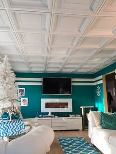 the living room is decorated in teal and white