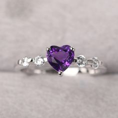 ◆ The ring is handcrafted from sterling silver and decorated with a dazzling 6*6 mm natural amethyst and tiny CZs. It is suitable for engagement/anniversary/daily occasion. ◆ Production Description: Main stone Type: Natural amethyst Main Stone Shape: Heart cut Main Stone Size: 6*6 mm(0.76ct) Side stone: CZ Metal: 925 Sterling silver - Other options available in the drop down menu ◆ Customization: √Free for Add Engraving √Other Metal Type Available √Other Gemstones & Shapes Available √Persona Silver Heart Rainbow Topaz Heart Rings Simple, Purple Sapphire Birthstone Ring With Diamonds, Silver Heart Cut Amethyst Ring Gift, Silver Amethyst Heart Cut Ring Gift, Purple Sapphire Ring With Diamond Birthstone, Purple Diamond Ring With Birthstone, Elegant Amethyst Heart Promise Ring, Fine Jewelry Heart Cut Amethyst Ring, Fine Jewelry Amethyst Ring Heart Cut