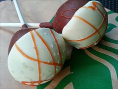 two chocolate covered desserts sitting on top of a green and white table cloth next to each other