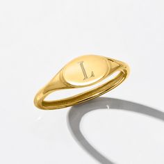 Ross-Simons - Single-Initial - Italian 14kt Yellow Gold Signet Ring Size 7. Here's a classic style that every collection calls for! Our stylish signet ring shines in polished 14kt yellow gold and can be engraved for FREE with a single initial in your choice of block or script type. Treat yourself to this timeless luxury or present it to someone special as a memorable gift they'll treasure. 1/4" wide. Made in Italy. 14kt yellow gold personalized signet ring. Gold Oval Initial Ring Stamped 14k, Classic Gold Stackable Sterling Silver Rings, Classic Gold-colored Sterling Silver Stackable Rings, Gold Sterling Silver Ring With Hallmarks, Oval Stackable 14k Yellow Gold Rings, Classic Gold Initial Ring Stamped 14k, Classic Gold Stackable Rings Stamped 14k, Personalized 14k Gold Oval Jewelry, Classic Engraved Yellow Gold Stackable Rings