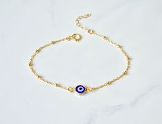 "Gold Filled Beaded Evil Eye Bracelet Handmade Turkish Glass and 18kt gold filled, every charm is made by hand so no one necklace is exactly the same. The charm on this necklace symbolizes good luck and safe keeping. Can be worn everyday and will not tarnish -Description Evil Eye Charm - Handmade Turkish Glass and 18kt gold filled, .5\" end to end Chain - 14kt Gold Filled Link or Beaded Chain Length- 5-8\" w/1\" extension See the last photo for bracelet measurement information The bracelets in t Gold Evil Eye Bracelet With Round Beads, Gold Plated Beaded Bracelets As Gift, Gold Bead Bracelet Gift, Gold Plated Round Beaded Bracelets For Gift, Gold-plated Round Beaded Bracelets As Gift, Round Gold-plated Beaded Bracelets As Gift, Yellow Gold Beaded Chain Bracelet As Gift, Gold Beaded Bracelets With Charms And Round Beads, Gold-plated Evil Eye Bracelet For Gift