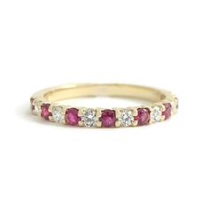 Ruby Diamond Ring Gemstone Wedding Band 14K Yellow Gold, .50 CTW This is a beautiful wedding band, anniversary ring or statement ring! Don't hesitate to ask any questions! Gemstones: 8 round rubies, .28 ctw Diamonds: 7 round brilliant cuts .22 ctw, G, SI1 Metal: 14K yellow gold Weight: 1.85 grams Stamped: 14K Size: 6.25 (can be sized for a small fee) Width: 2.2 mm top of ring Stock: W2098 Anniversary Ruby Eternity Band With Round Cut, Classic Round Ruby Ring With Half Eternity Band, Classic Round Half Eternity Ruby Ring, Classic Ruby Eternity Band For Wedding, Ruby Half Eternity Ring With Diamond In Round Band, Ruby Diamond Ring With Half Eternity Round Band, Ruby Eternity Band With Prong Setting For Wedding, Fine Jewelry Ruby Half Eternity Ring For Anniversary, Anniversary Ruby Ring Half Eternity Style