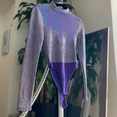 New Never Worn Silver Shiny Stretch Bodysuit, Metallic Shimmer Fitted Bodysuit, Shimmer Stretch Bodysuit For Party, Party Shimmer Stretch Bodysuit, Party Bodysuit With Shimmer And Stretch, Shiny Disco Bodysuit For Parties, Metallic Long Sleeve Bodysuit For Party, Metallic Long-sleeve Bodysuit For Party, Stretch Shiny Bodysuit For Party