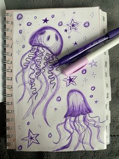 a drawing of a jellyfish with stars on it and a purple marker pen next to it