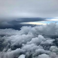 the view from an airplane looking down on some clouds