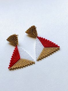 - Miyuki seed bead hand-beaded gold, red, white  seed bead  triangle stud earrings - 24K gold plated Miyuki seed beads - Earrings length is 4 cm (1.6 inches) - The earrings are not heavy, the materials are very light - Colors may appear slightly different on screen due to differences in resolution, brightness, and contrast JEWELRY CARE - Keep jewelry dry - Take it off before taking shower, bath, swimming or exercising - Makeup, perfume, hairspray apply before wearing jewelry - Store your jewelry somewhere dry, not in the bathroom Handmade in Cyprus PACKING All items are sent in a presentable gift box SHIPPING:  This item will be sent by regular registered international airmail (with the tracking number). Visit my shop for more jewelry: https://www.etsy.com/shop/JeweleryByIlze CONTACT If yo Handmade White Triangle Beaded Earrings, Triangle Shaped White Jewelry For Gifts, White Triangle Jewelry For Gift, White Triangle Jewelry Gift, White Triangle Earrings For Gift, Beaded Triangle Earrings For Gifts, Triangle Beaded Earrings For Gifts, Elegant Triangle Beaded Earrings Gift, Elegant Triangle Beaded Earrings For Gift