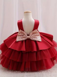 Make your little one the belle of the ball with this classic red princess gown. The dress boasts a sleek, sleeveless top and a plush, multi-layered tulle skirt that's made for twirling. A shimmering gold bow adorns the waist, providing a beautiful contrast to the deep red. It's an ideal choice for flower girls, birthday parties, or any event where making a statement is a must. Size Chart Size Chart US Shoulder (inches) Bust size (inches) Waist size (inches) Length (inches) 6-9M 7.9 20.5 19.7 17. Holiday Princess Ball Gown In Tulle, Christmas Princess Ball Gown, Elegant Christmas Tutu Dress In Tulle, Elegant Christmas Tulle Tutu Dress, Red Sleeveless Ball Gown For Dress-up, Wedding Holiday Dress With Tulle Ruffles, Elegant Holiday Tutu Dress With Ruffles, Princess Tulle Holiday Dress For Christmas, Princess Style Tulle Holiday Dress For Christmas