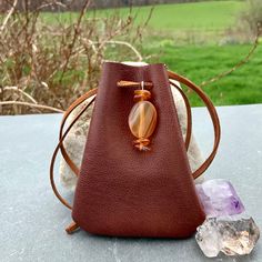 "Vegan Eco Leather Medicine Bag, Shaman Bag or Amulet Pouch to wear around your neck-or hang in your Car! A place for things that have Spiritual Meaning for you-your Sage,Crystals,or that pretty rock your 3 year old gave you.... 3 3/4\"deep 2 3/4\"wide Choice of 2 colors:- - -Black /Double Terminated Labradorite Crystal Point -Russet Brown/Red Agate and Baltic Amber Stones Please note these are natural Gemstones- each one is completely different...like snowflakes! BUY ANY 4 MEDICINE BAGS(VEGAN L Handmade Bags For Daily Use, Brown Portable Pouch For Gift, Portable Pouch Shoulder Bag As Gift, Small Brown Bag For Gift, Small Brown Gift Bag, Adjustable Leather Bag Gift, Brown Portable Bag As Gift, Brown Travel Bag For Gift, Brown Coin Purse For Gifts