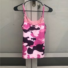 a pink camo tank top hanging on a door