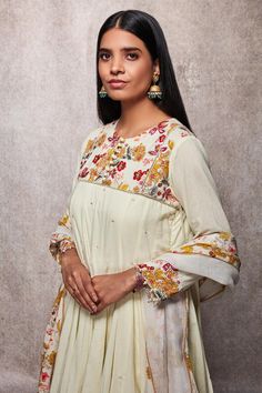 Off white kalidar kurta with floral embroidered yoke and sequin detailing. Paired with dhoti and scallop hem dupatta.
Component: 3
Printed, Embroidered
Neckline: Round
Sleeve Length: Three Quarter
Fabric: Mulmul, Kota Doria
Color: White
Drawstring with tassels at the side
Front potli placket
Pearl detailing at the sleeves
Printed detailing on the dhoti
Tassels on the dupatta
Note: Potli shown in the image is not for sale - Aza Fashions Dhoti Pants, Scallop Hem, Embroidered Neckline, Fashion App, Scalloped Hem, Pant Set, Set For Women, Aza Fashion, Three Quarter