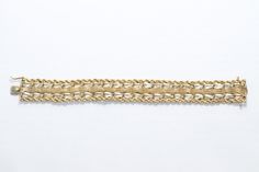 Stunning vintage 14K yellow gold threaded charm bracelet made between the 1960's to 1970's with a beautiful rope and Florentine finished design. This charming bracelet is 7 inches long and 3/4 inches in width. This with bracelet is made with a secure box lock with an additional safety clasp. The bracelets total weight is 31.5 grams. This bracelet is hallmarked 14K yellow gold and has been tested by a professional to be accurate. Formal Rope Chain Bracelet Jewelry, Elegant Gold Rope Chain Bracelet For Formal Occasions, Formal Rope Chain Bracelet, Elegant Formal Gold Rope Chain Bracelet, Vintage Gold Braided Bracelets As Gift, Vintage Handmade Yellow Gold Bracelet, Handmade Vintage Yellow Gold Bracelet, Elegant Formal Rope Chain Bracelet, Gold Threads