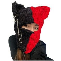 a woman wearing a red and black knitted hat with chains attached to her face