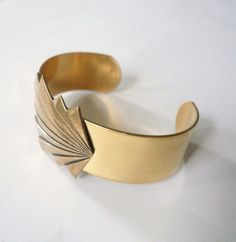 Antique Gold Cuff Bracelet Collectible, Antique Brass Cuff Bracelet Collectible, Adjustable Vintage Gold Cuff Bracelet, Vintage Gold Brass Cuff Bracelet, Antique Gold Bangle Cuff Bracelet, Vintage Antique Gold Brass Cuff Bracelet, Antique Gold Cuff Bracelet For Formal Occasions, Vintage Gold Bangle For Gift, Elegant Antique Gold Bangle