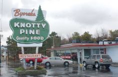 a sign for knotty pine quality food in the rain