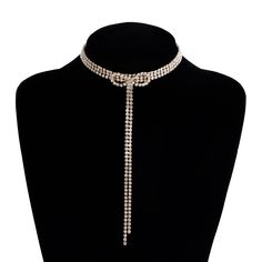 ✦ Make a dazzling entrance with our Exquisite Sparkly Rhinestones Ribbon Choker. This necklace is designed to turn heads and elevate your look. The rhinestones are intricately arranged in a ribbon pattern, reflecting light and creating a sparkling effect. The adjustable ribbon closure ensures a perfect fit, and the tassel detail adds a touch of movement and charm. Whether worn for a special occasion or to add a touch of glamour to your everyday style, this sparkly choker necklace is a must-have Adjustable Metal Rhinestone Necklace With Bling, Glamorous Rhinestone Alloy Jewelry, Adjustable Rhinestone Necklaces For Evening, Adjustable Rhinestone Evening Necklace, Adjustable Jeweled Crystal Necklaces, Adjustable Sparkling Rhinestone Necklace, Formal Alloy Rhinestone Necklaces, Adjustable Rhinestone Necklaces For Party, Formal Rhinestone Alloy Necklaces