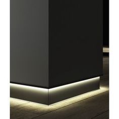 a black box with some lights on the side and wood flooring in front of it