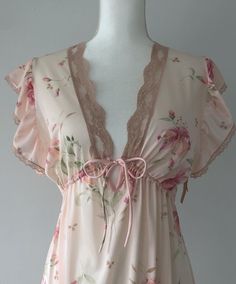 Stunning vintage 70s nightie/lingerie, and deadstock on top of it all! Adding a slip could easily turn it into a day dress. Still has original hang tags attached at the left arm. Sheer, nylon, adjustable in the under bust. Light pink, airy, dreamy ruffled shoulders. Flawless condition. Plenty of stretch.  Shoulders 15" Chest 19-21" (stretches) Ribs/underbust adjustable with tie Length (shldr to hem) 53" I would say this would suit anyone XS-M.  Super romantic and gorgeous! NEW ITEMS WEEKLY!  Come visit me on Instagram to have access to items before they are posted to the Etsy shop.  @rubyhausvintage All of the items I sell are pre-loved, which means that signs of wear are to be expected.  This brings unique character to an item! I do my best to note any major flaws I find in the item descr Historic Nightgowns, Sheer V-neck Coquette Sleepwear, Sheer Fitted Sleepwear For Spring, Fitted Sheer Sleepwear For Spring, Spring Coquette Lace Sleepwear, Sheer Fitted Coquette Sleepwear, Fitted Feminine Nightgown With Floral Print, Fitted Feminine Floral Print Nightgown, Coquette Spring Sleepwear With Lace Trim