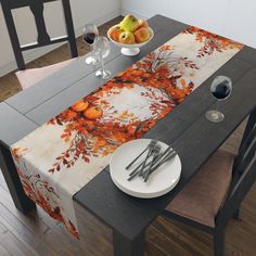 the table is set with two plates and silverware next to an orange tree design