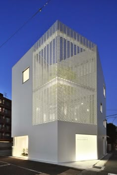 a white building is lit up at night