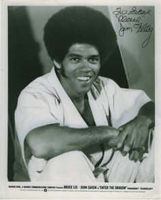 a black and white photo of a man with an afro