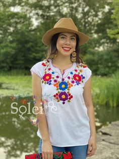 This Beautiful Floral Hand Embroidered Blouse is the perfect Top for Everyday use or a special event. This blouse is hand embroidered by Mexican Artisans and is completely one of a kind! This blouse comes in one size which fits sizes Small and Medium. More Colors Available here: https://www.etsy.com/es/listing/834786779/blusa-floral-bordado-a-mano-blusa-floral?ref=listing_published_alert Bohemian Embroidered Top With Embroidered Border For Festivals, Summer Festival Embroidered Top With Geometric Patterns, Summer Festival Embroidered Top With Geometric Embroidery, Embroidered Folk Blouse For Beach, Bohemian Blouse With Geometric Embroidery For Summer, Folk Embroidered Beach Blouse, White Bohemian Embroidered Top For Festival, Folk Style Embroidered Beach Blouse, Folk Style Embroidered Top For Vacation