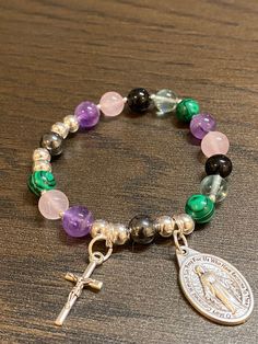 Item details Handmade Rosary Bracelet for Women Stretch Muti-colored Bracelets, Miraculous medal Medal and small cross Rosary Beads are a mix of rose quartz, malachite, amethyst, flourite, black tourmaline and hematite The size of the rosary bracelet is 6.5 inches. This will be a great gift for confirmation! A unique and beautiful personalized rosary bracelet! It will make a perfect religious themed gift or inspiration for yourself. The beads used on every piece are handpicked. We make sure that Nickel Free Cross Bracelet With Spiritual Style, Pink 8mm Bead Spiritual Rosary Bracelet, Hand-strung Rosary Bracelet With Round Beads For Meditation, Pink Hand-strung Spiritual Rosary Bracelet, Traditional Adjustable Hand-strung Rosary Bracelet, Nickel-free Cross Bracelet For Spiritual Style, Pink Cross-shaped Rosary Bracelet Gift, Cross Rosary, Handmade Rosary