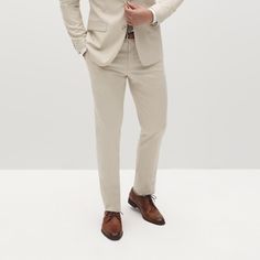 Embody laid-back elegance in the light tan suit pants. This mod, sandy shade with visible woven texture on these tan slacks is designed to suit you from sunny celebrations to the office, candlelit dinners, and everywhere in between. The men’s tan dress pants are crafted from signature Eco Stretch fabric, sure to keep you cool and comfortable through it all. Pair with the matching Men’s Tan Suit Jacket in the perfect light beige color for a clean look in a 2-piece suit, or style these suit pants Formal Cream Straight Pants, Classic Wedding Bottoms For Spring, Classic Spring Wedding Bottoms, Elegant Neutral Suits For Formal Occasions, Classic Fitted Chinos For Summer, Tailored Cream Pants With Pressed Crease, Classic Fitted Summer Chinos, Cream Trousers With Pressed Crease, Elegant Neutral Formal Suit