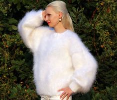 "FUZZY HAND KNITTED MOHAIR SWEATER by SuperTanya Hand knitted with love and care for your comfort and complete satisfaction. Its clear and plain design makes this warm and breathable fashion cloth suitable for any occasion. Wherever you are, the lovely white color will make you feel like a star. At office, shopping center or at home - you will be the \"only one\", around. With the crew neckline style you will fully comply with the fashion trends for the upcoming season. This premium quality, han White Soft Knit Winter Sweater, White Cozy Fit Knitted Sweater, Cozy Fit White Knitted Sweater, Cozy Fit White Knit Sweater, Elegant Oversized White Sweater, Cozy Soft Knit White Sweater, White Cozy Soft Knit Sweater, Cozy White Soft Knit Sweater, Cozy White Sweater With Soft Texture