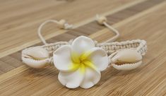 "Handmade Plumeria Flower Hemp Bracelet. Also available in a variety of colors to choose from. 🌿Natural Color Hemp Cord -with 3 Hawaiian Plumeria Flower Charms 🌸Plumeria Flower Meaning: In Hawaiian culture, the plumeria symbolizes Positivity & New Life and is used to celebrate special occasions. 💕Fits Most Size- Pull the knots to adjust to you wrist. Adjustable from 5\" Inches up to 10\" Inches Around Wrist of Anklet. Wear this beautiful design as a bracelet or anklet. 💫Handmade - Hawaii White Flower Jewelry For Vacation, Adjustable Flower Beaded Bracelets For Beach, Flower Shaped Beaded Bracelets For Beach, Adjustable White Bracelet With Flower Decoration, Bohemian Flower Bracelets For Vacation, Handmade Flower Bracelets For Beach, Adjustable Flower Friendship Bracelets For Beach, Handmade Flower Bracelet For Beach, White Flower Bracelets For Vacation