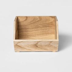 a small wooden box sitting on top of a white surface