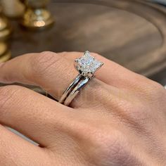 a woman's hand with a diamond ring on it